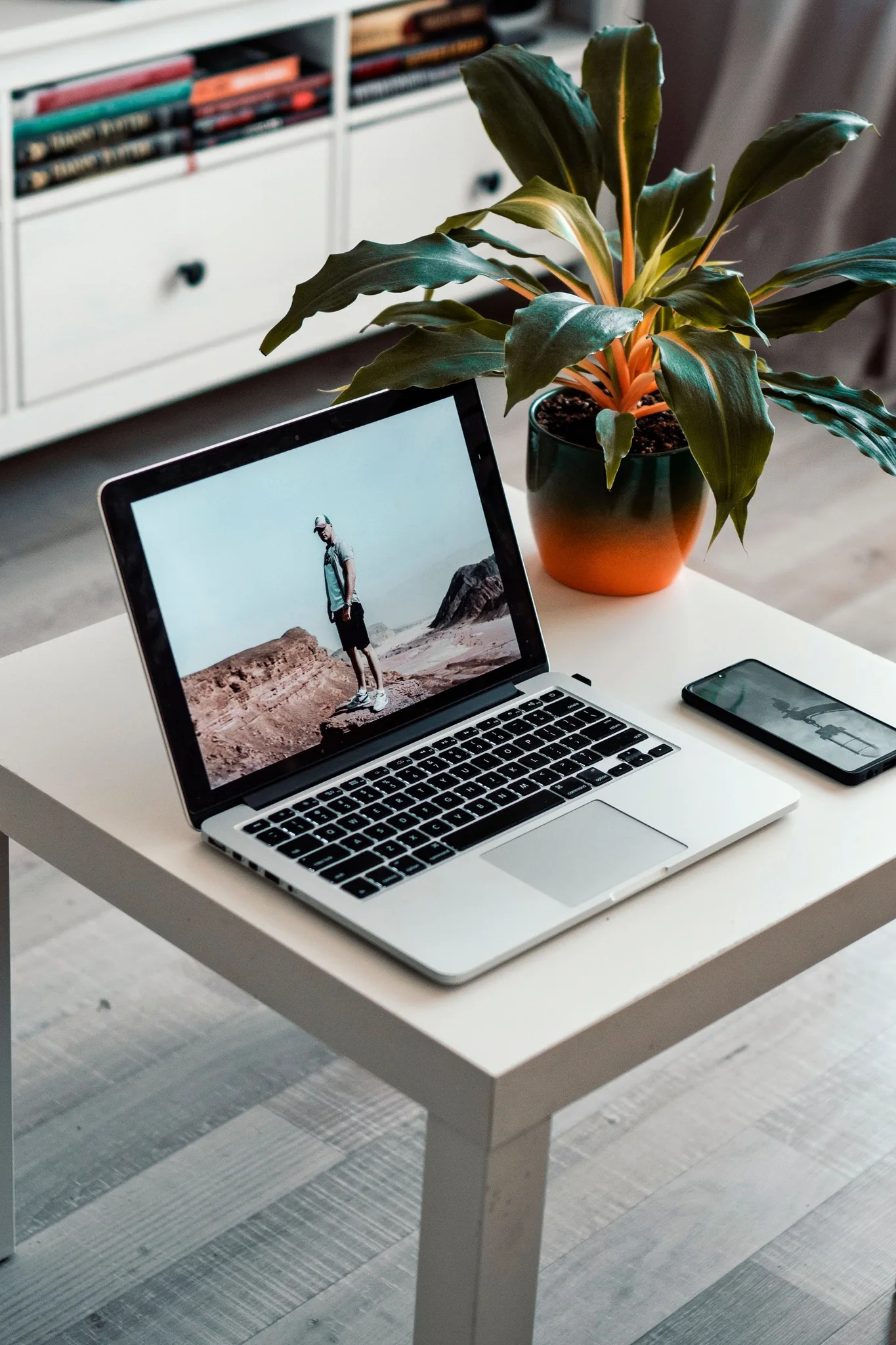 Open notebook next to a laptop and pen on a desk, ideal for business and planning.